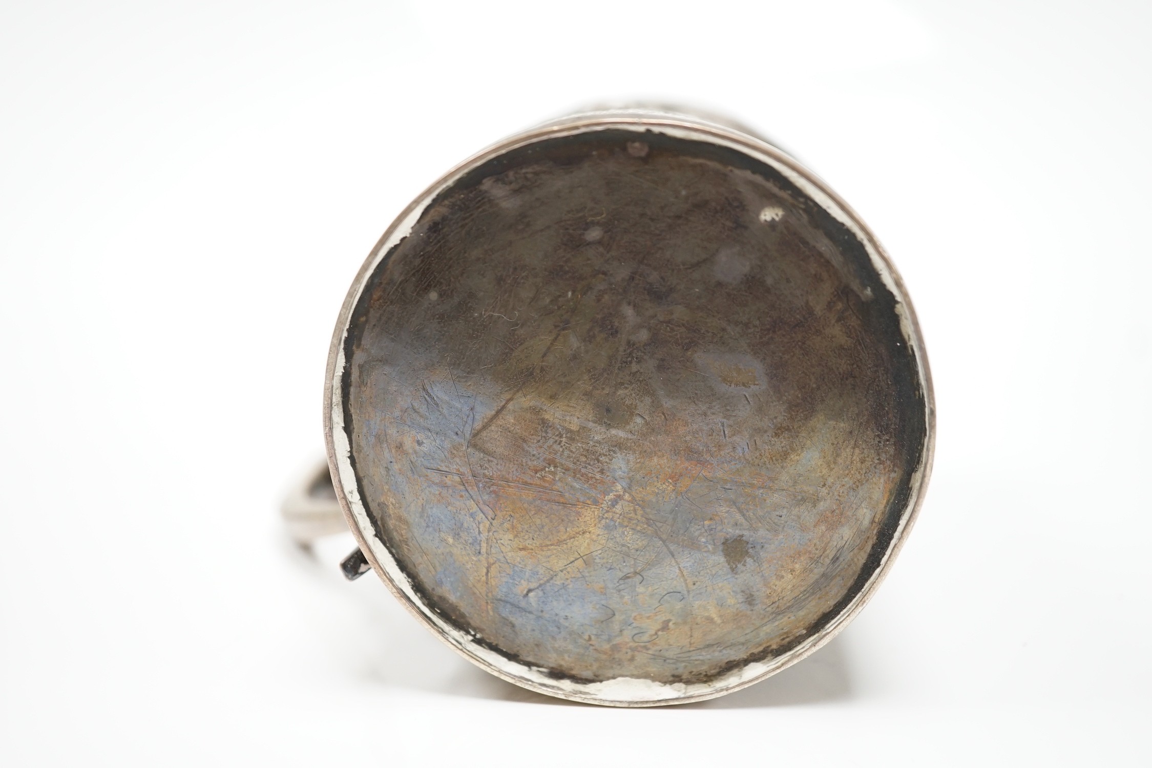 A George III silver mug, with later embossed decoration (af.), Charles Hougham?, London, 1812, height 81mm.